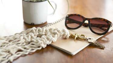picture of sunglasses and a macrame keychain