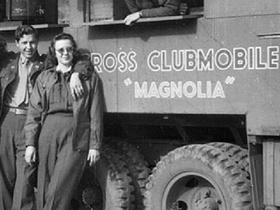 Man and woman standing outside of Clubmobile